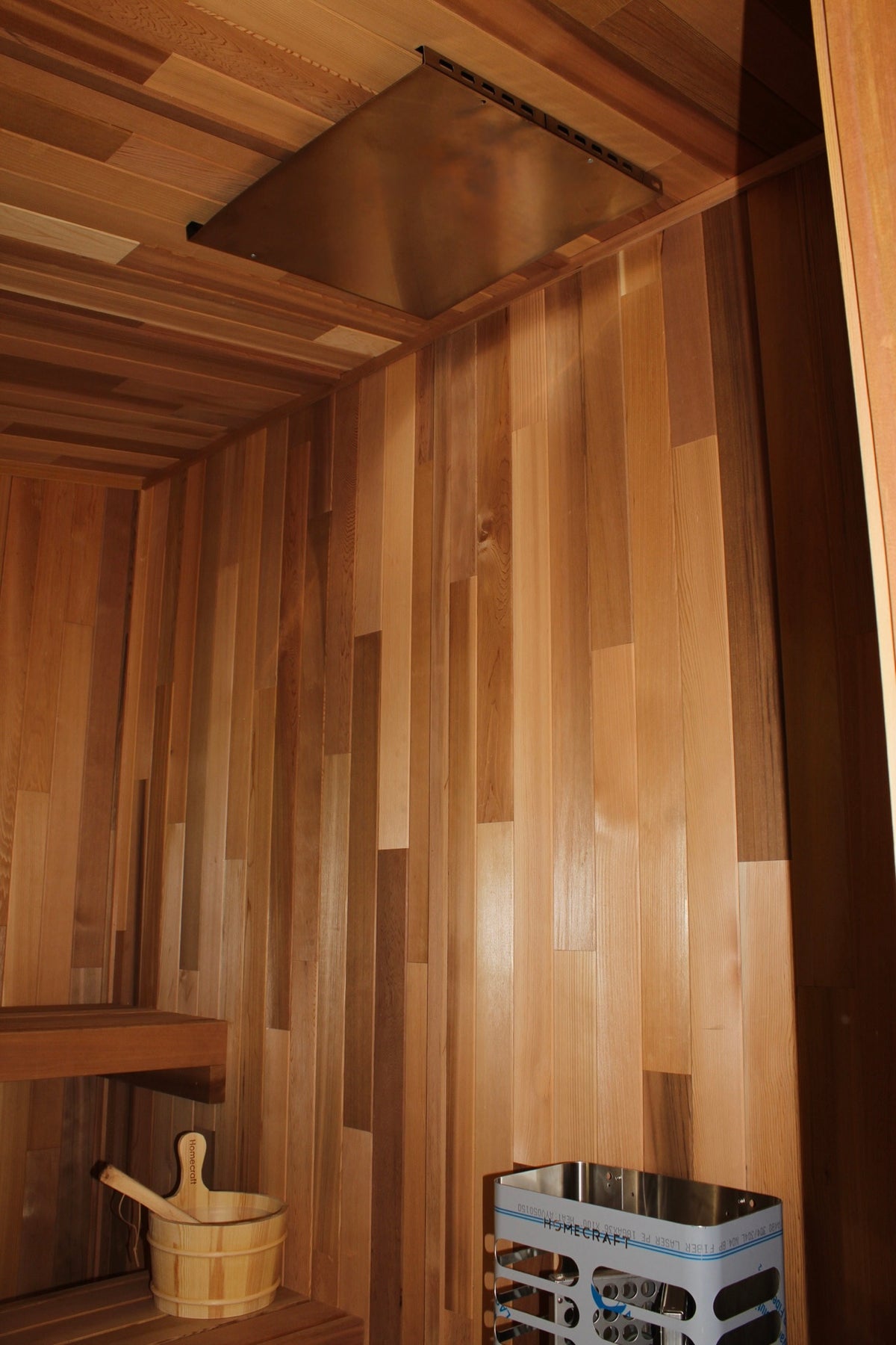 Ceiling heat shield in a cedar sauna interior