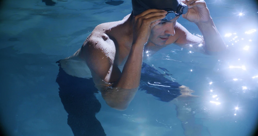 J16 Man Putting On Goggles for swim spa exercise