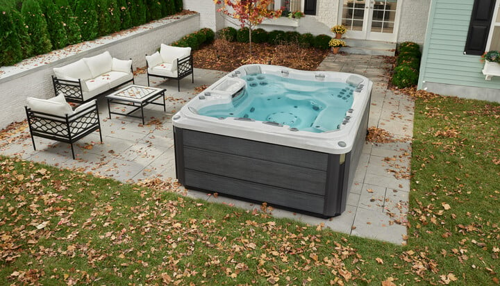 Sundance Spas 880 - hot tub with outdoor patio furniture nearby